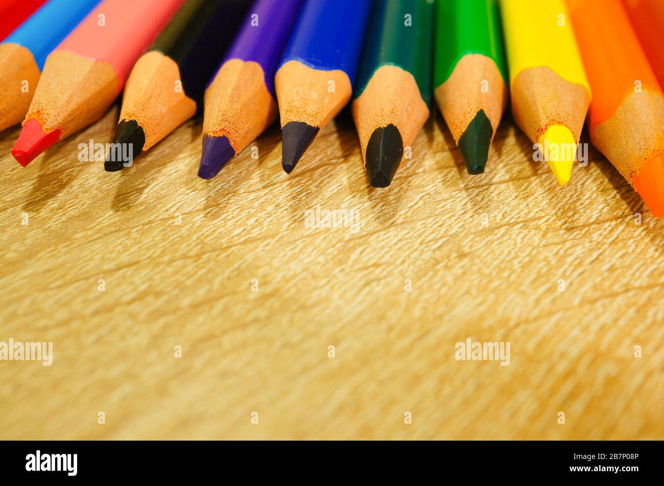Closeup shot of colored pencils near each other on a wooden surface Stock Photo