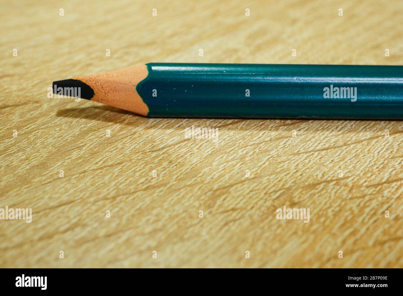 Closeup shot of a colored pencil on a wooden surface Stock Photo