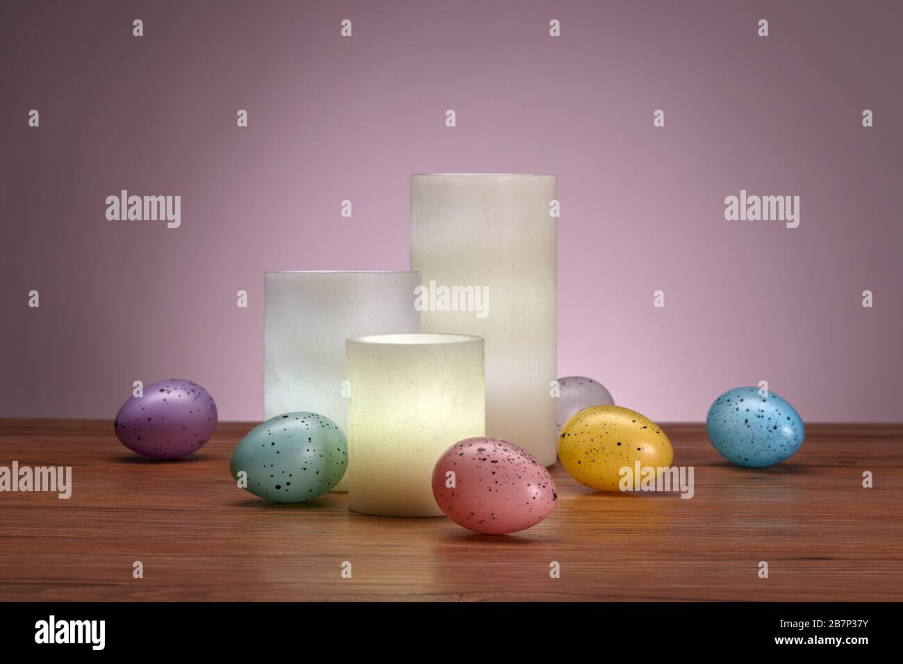 Glowing Wax Candles and Easter Eggs Stock Photo