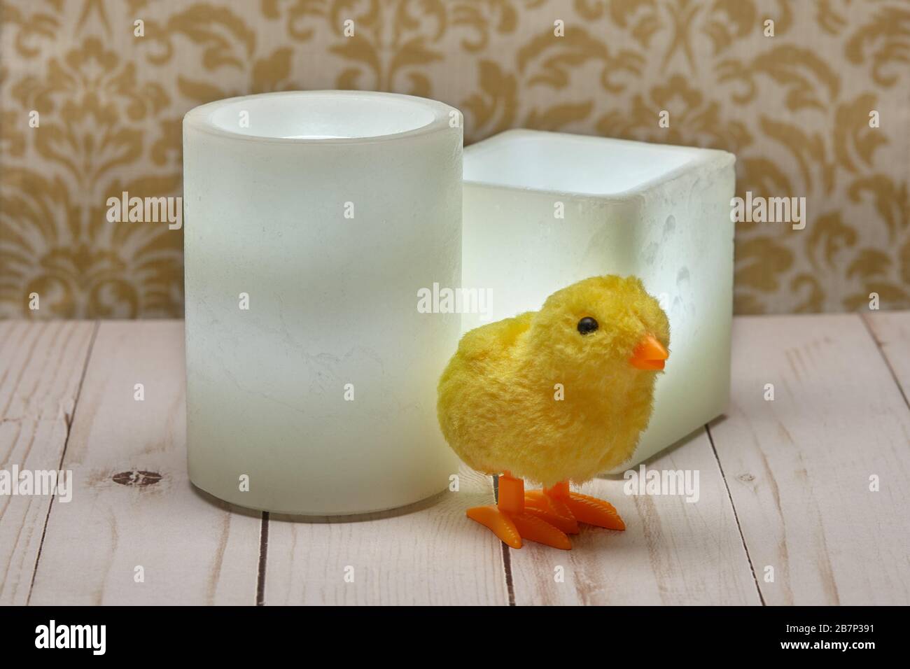 Young children making fun colorful layered granulated wax candles in home  by pouring powder in old baby food jar and inserting wick inside. Hobby  concept. Stock Photo