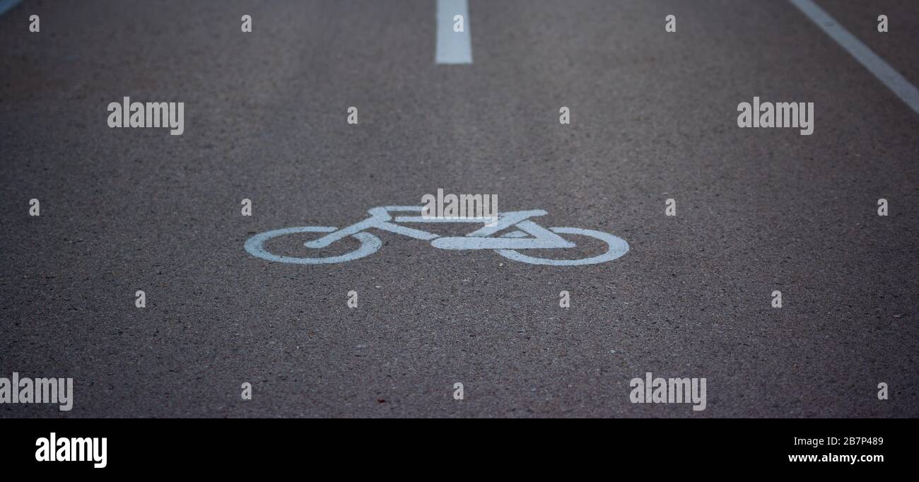 detail of a traffic sign of a bicycle painted in white on the asphalt ...