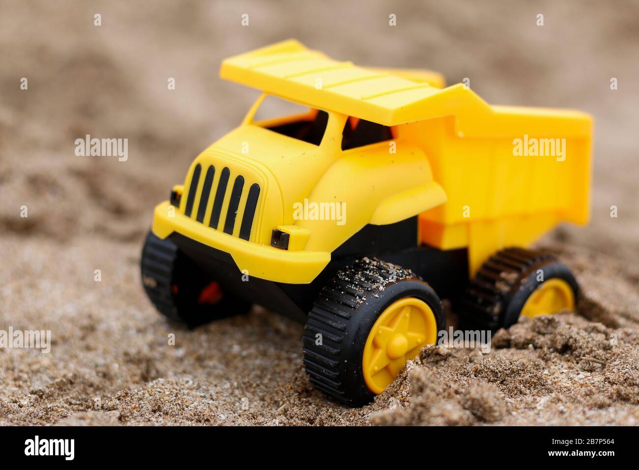 yellow toy truck on the sand Stock Photo Alamy
