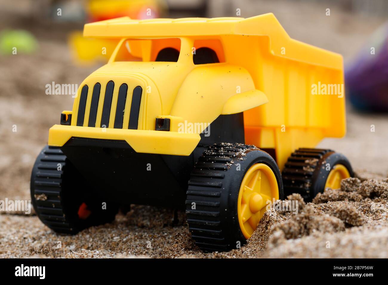 yellow toy truck on the sand Stock Photo Alamy