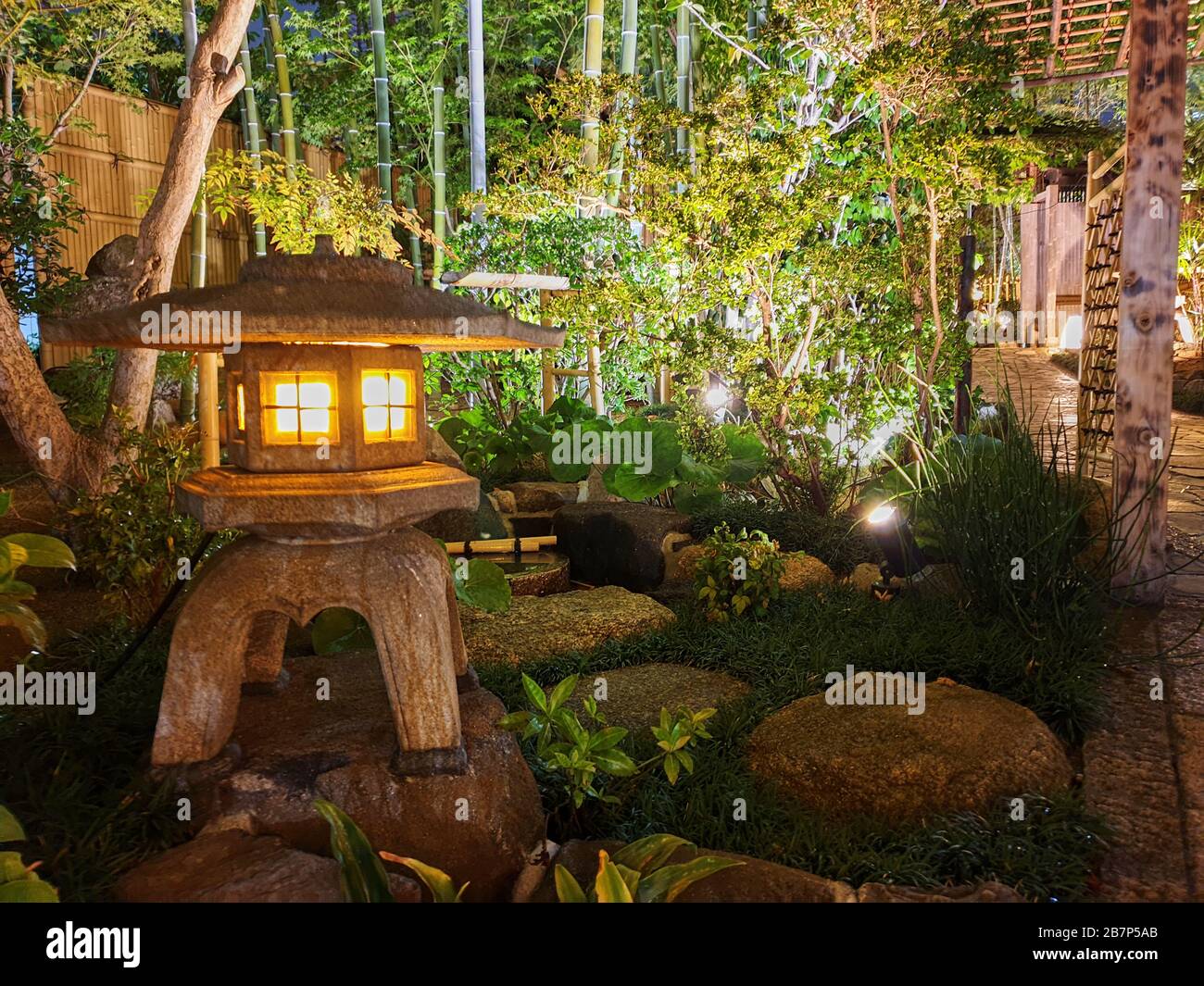 Japanese style garden with nicely illuminated sculpture Stock Photo