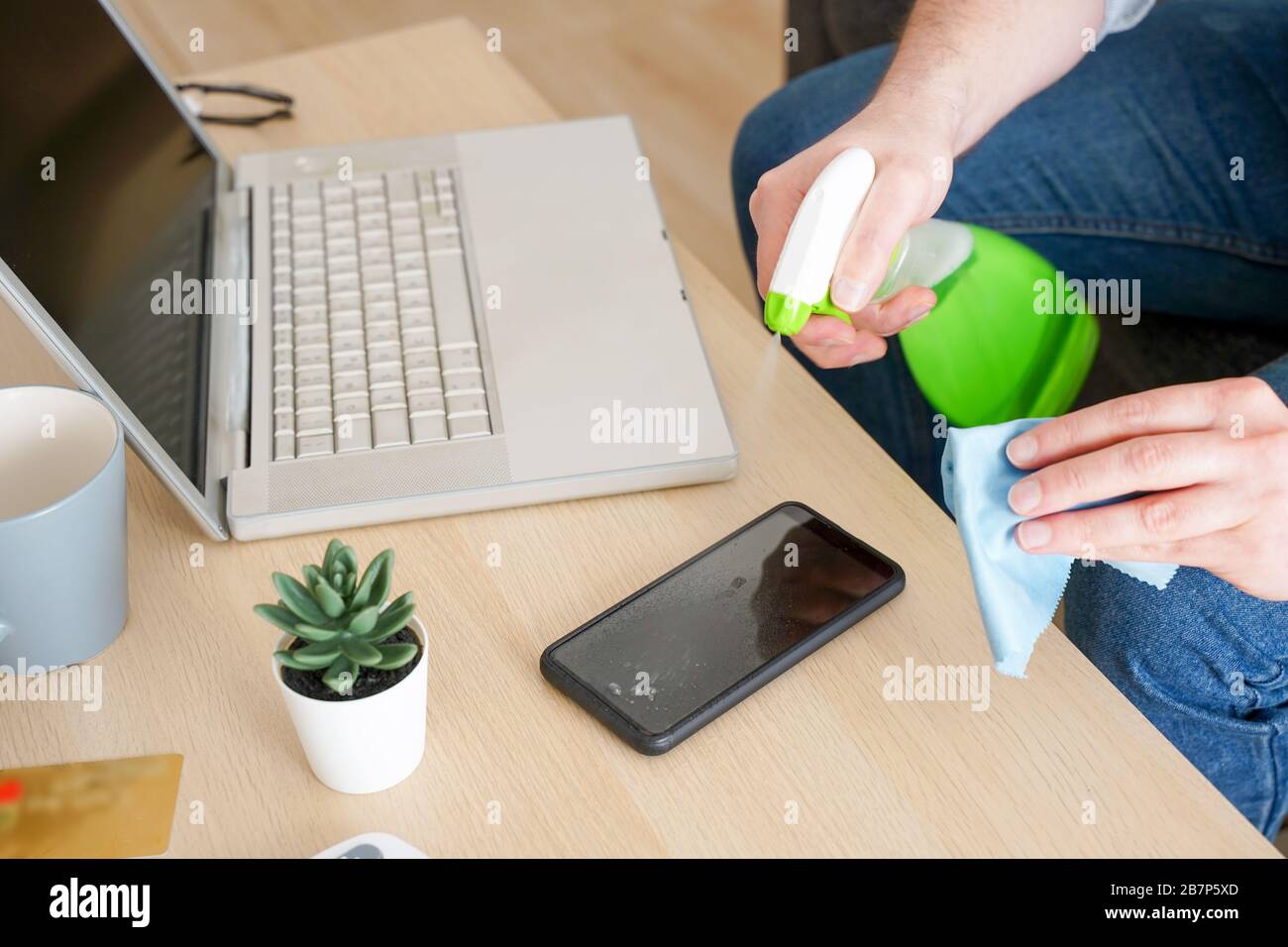 Close up of man cleaning and sanitizing tech devices Stock Photo Alamy