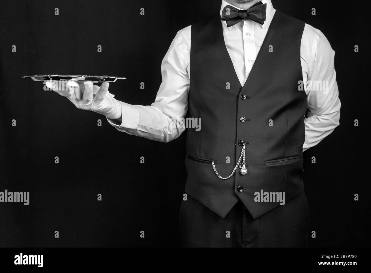 Butler or Waiter Holding Silver Tray. Concept of Service Industry and Professional Hospitality and Courtesy. Stock Photo