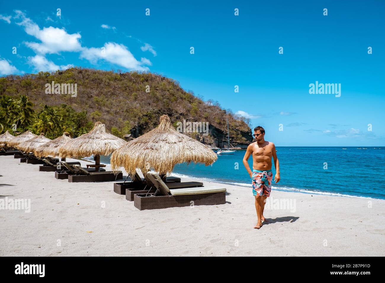 St Lucia caribbean sea, young guy on vacation at the tropical island Saint Lucia, men in swim short near the beach Stock Photo