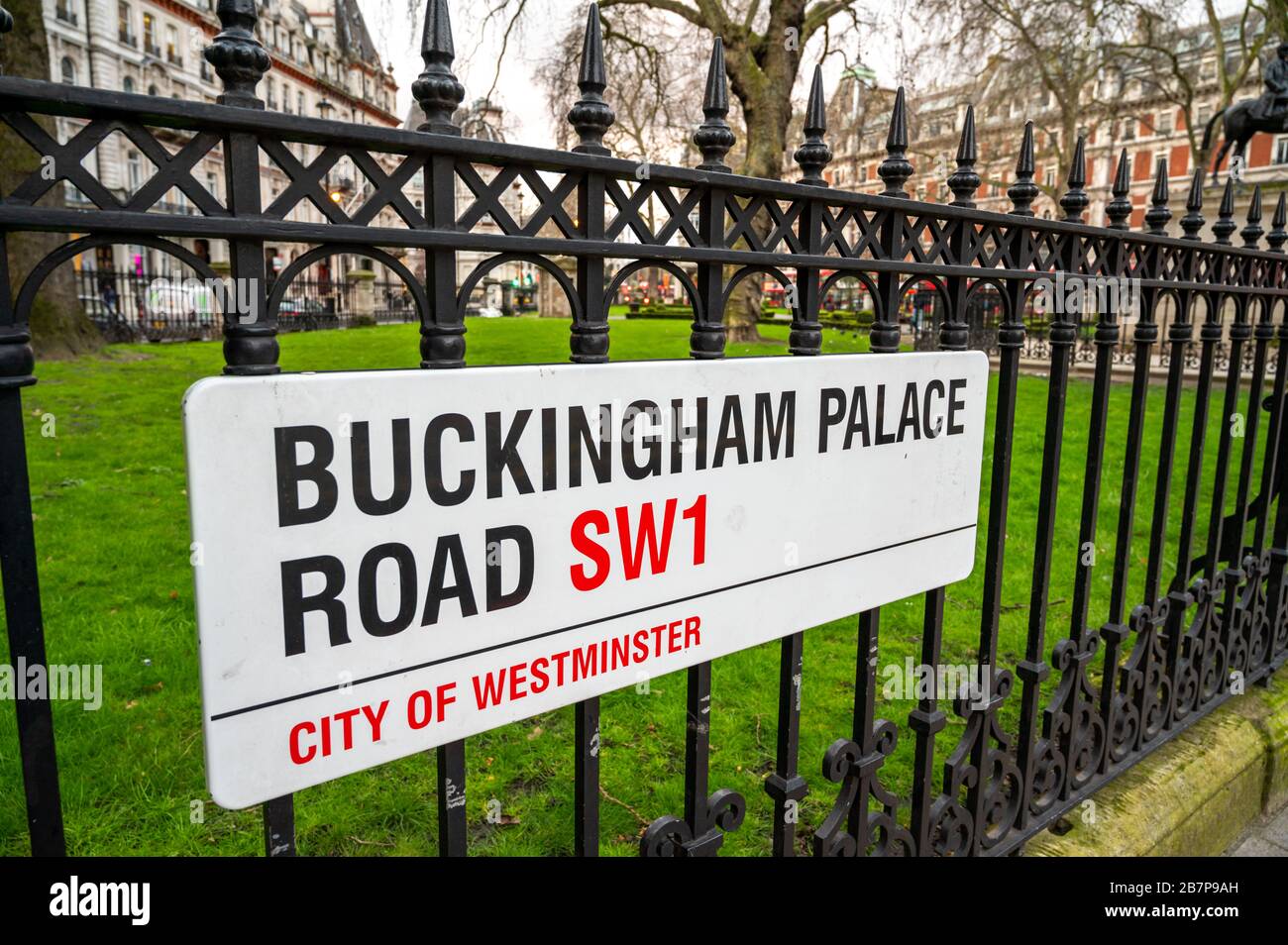 Buckingham Palace Road SW1 street sign on wrought iron fence by Grosvenor Gardens and Victoria train station, London, England. Stock Photo