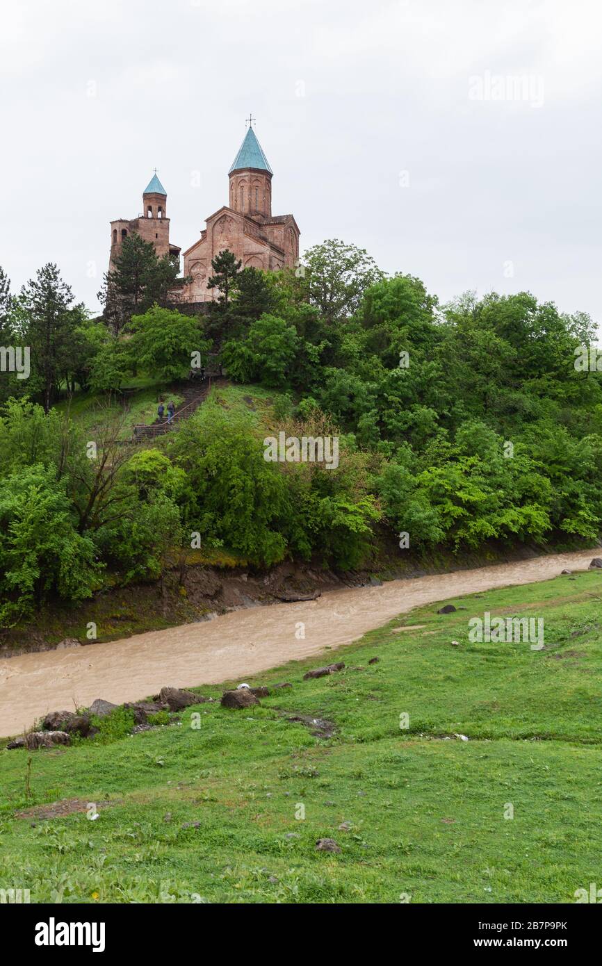 Georgian landscape with mountain river and Gremi, 16th century architectural monument, the royal citadel and the Church of the Archangels in Kakheti, Stock Photo