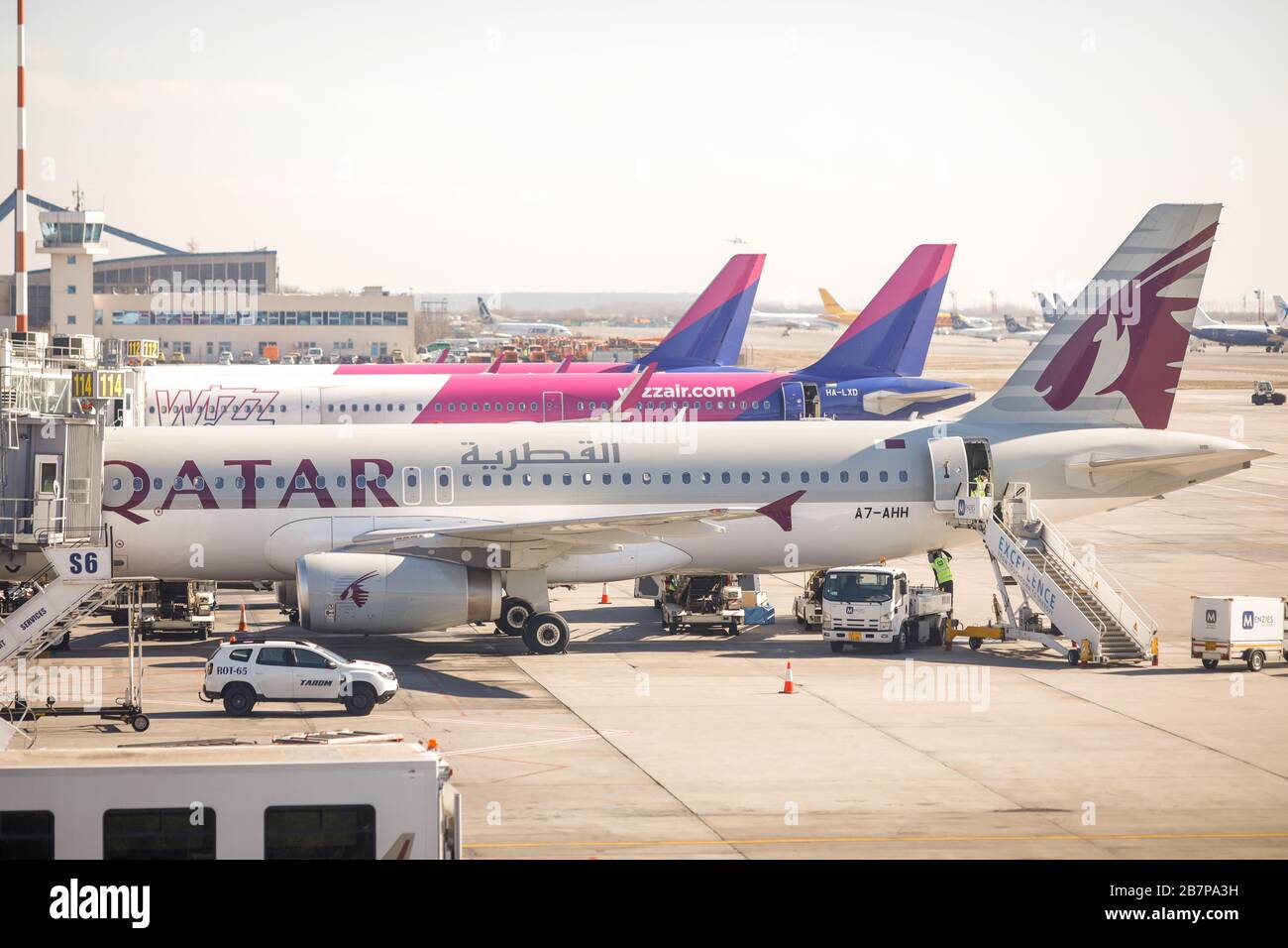 Otopeni, Romania - February 25, 2020: Wizzair and Qatar Airways airplanes on Henri Coanda International Airport, near Bucharest, Romania. Stock Photo