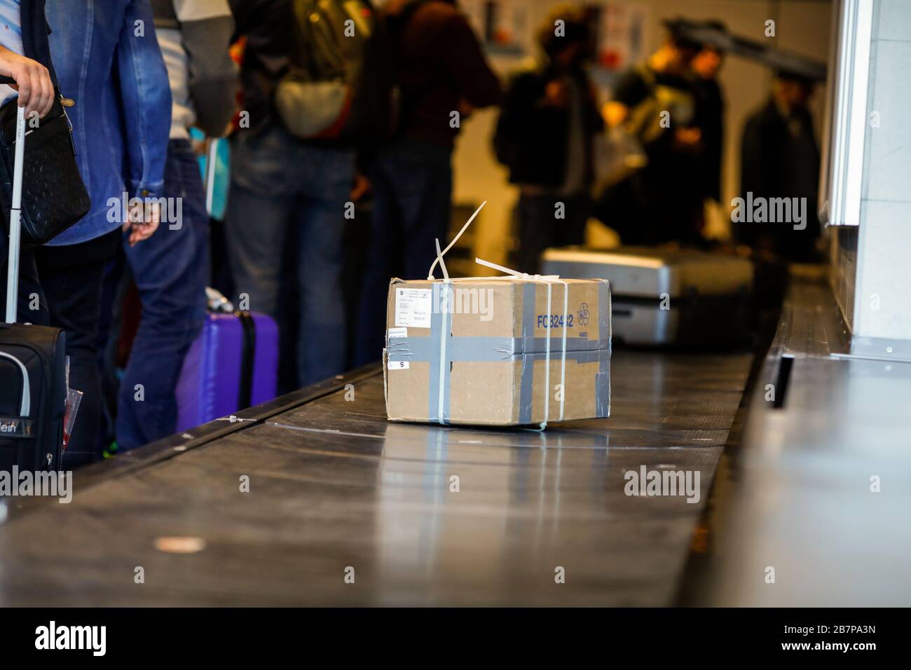 Otopeni, Romania - February 25, 2020: Cardboard box luggage on the baggage carousel in an international airport. Stock Photo