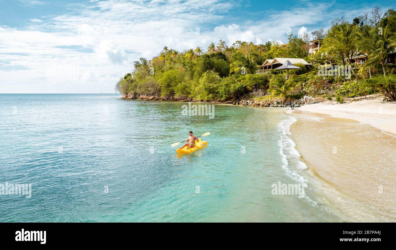 St Lucia caribbean sea, young guy on vacation at the tropical island Saint Lucia, men in swim short near the beach Stock Photo