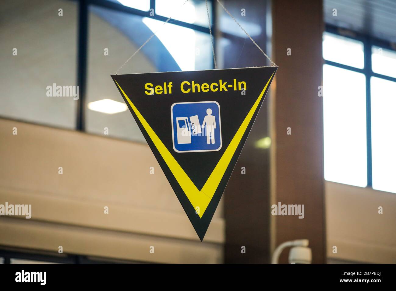 Self check-in sign inside an international airport Stock Photo