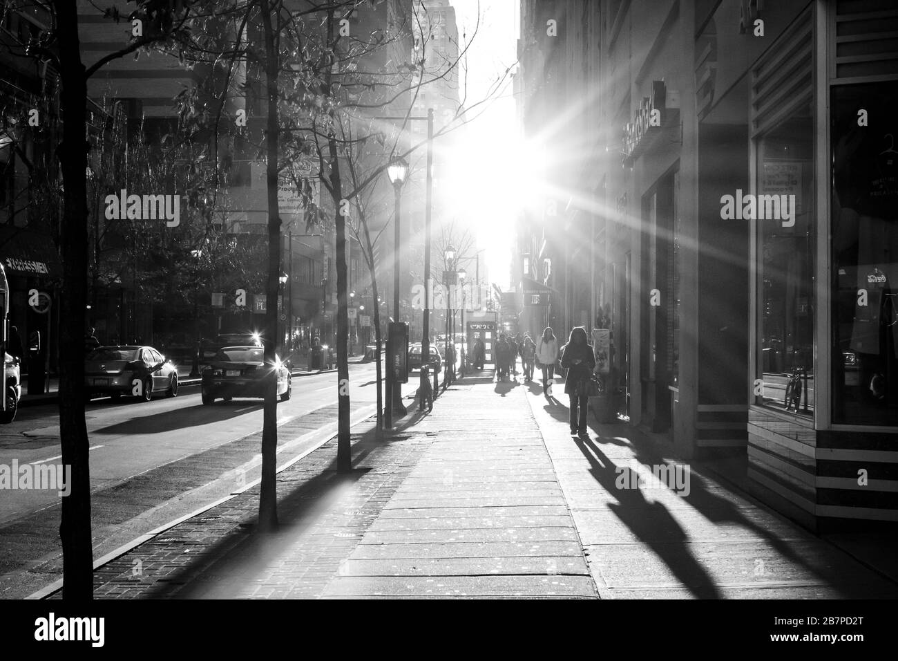 Sun shines brilliantly down a city street Stock Photo
