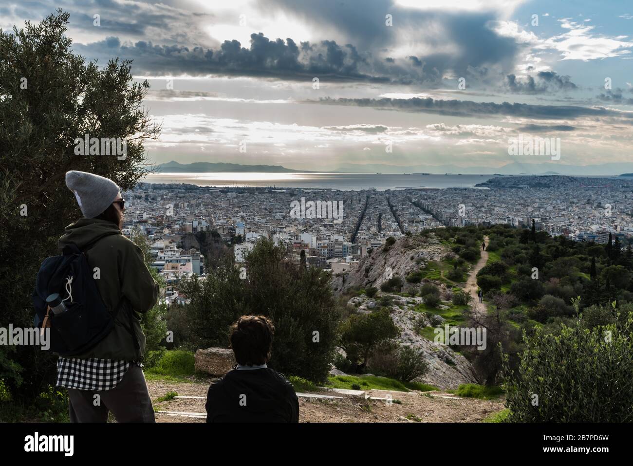 Athens Old Town, Attica/ Greece - 12 28 2019: Attractive young couple posing in front of the  Athens skyline Stock Photo