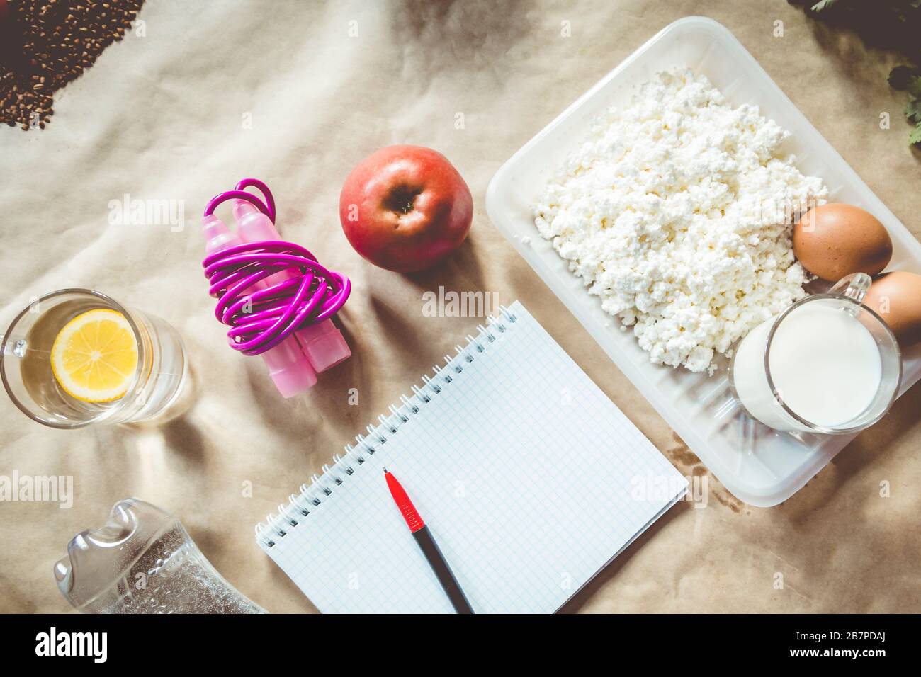 Diet planning. Meal plan. skipping rope and healthy food a bottle of water, apple, cottage