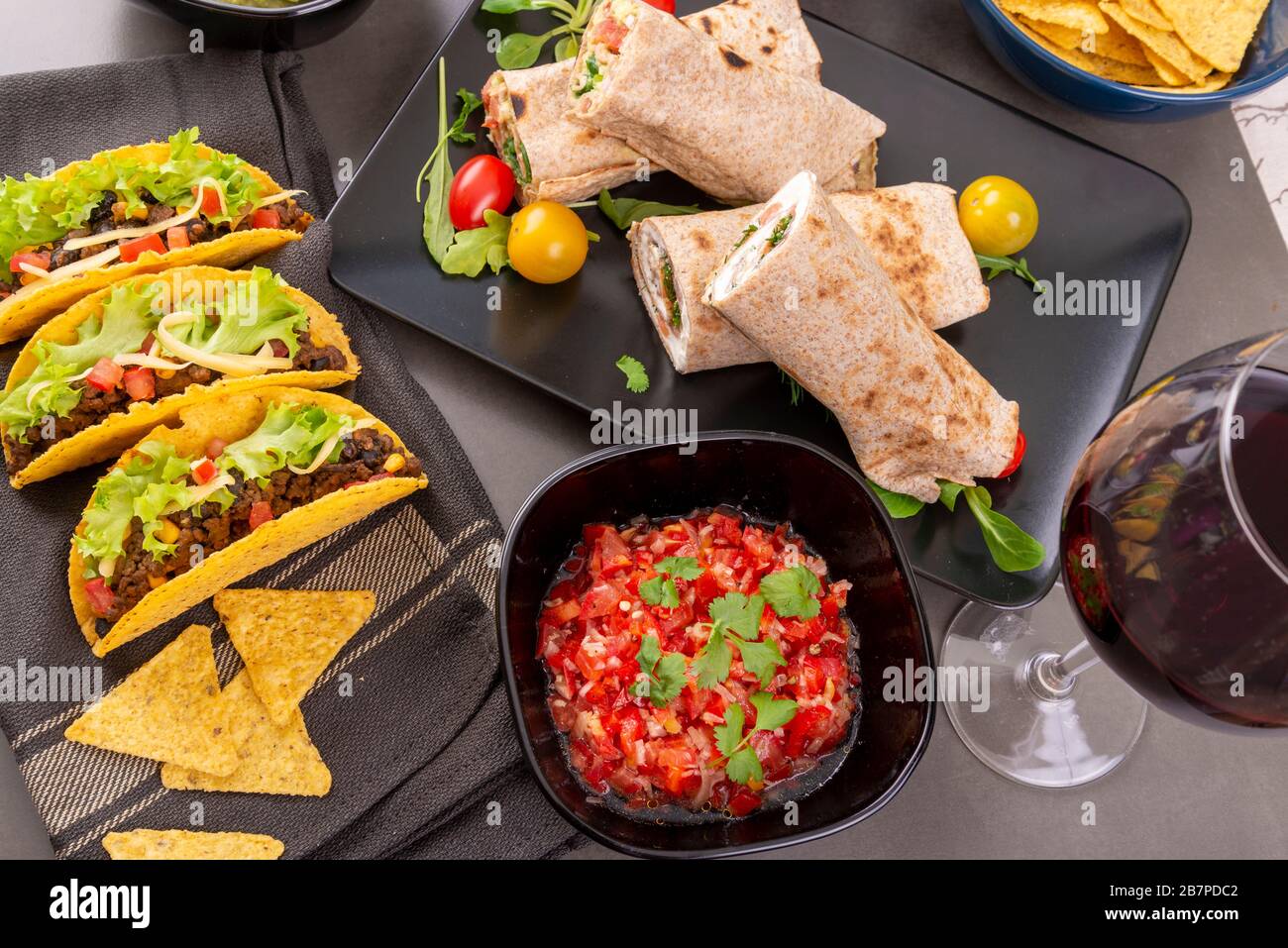 Various mixed Mexican dishes. Tacos, burritos, fajita, salsa, nachos on