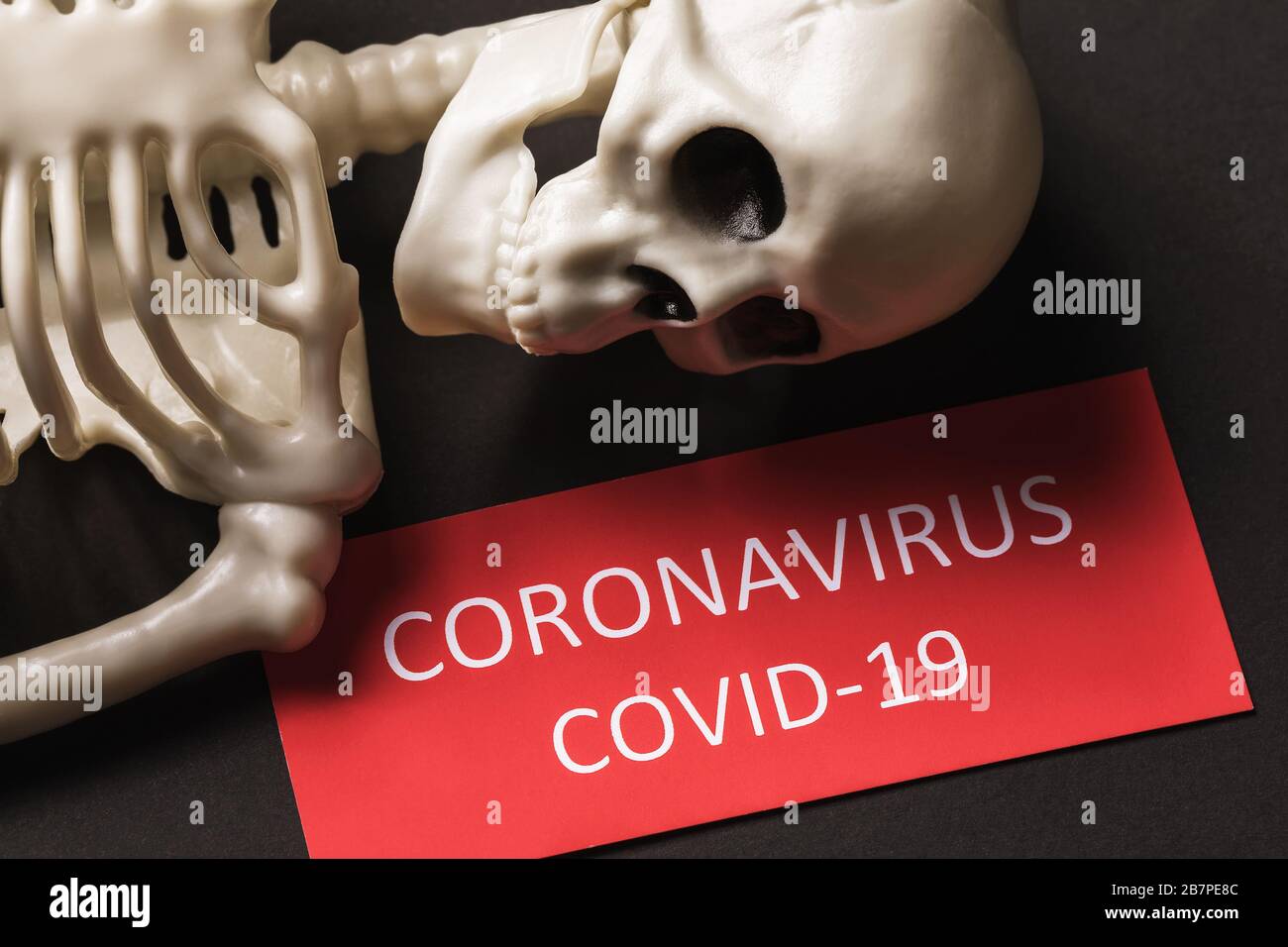 Skeleton and tag with text. Coronavirus victims concept COVID-19 Stock Photo