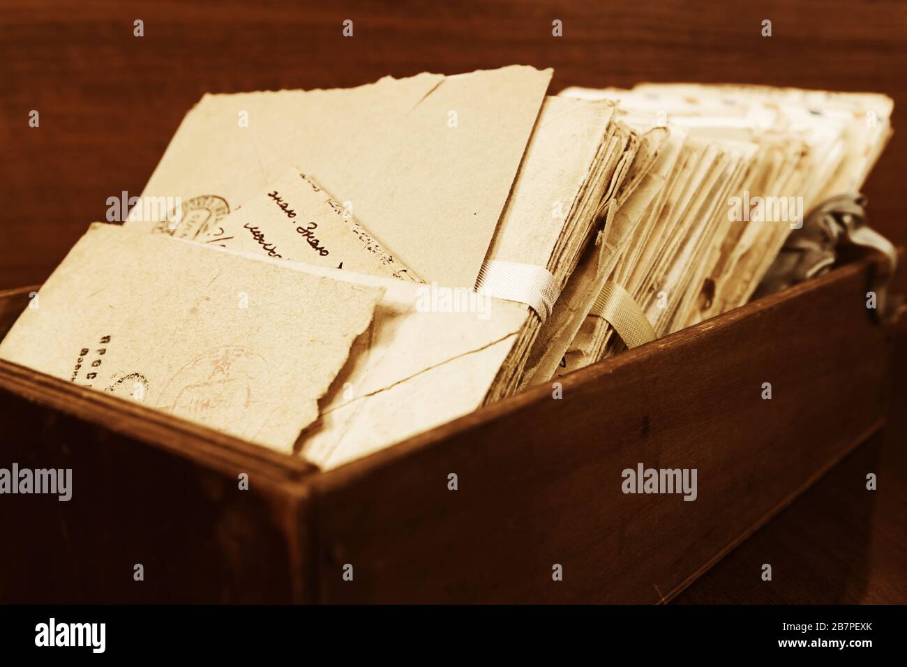 Stack of the old postal letters in a wooden box Stock Photo