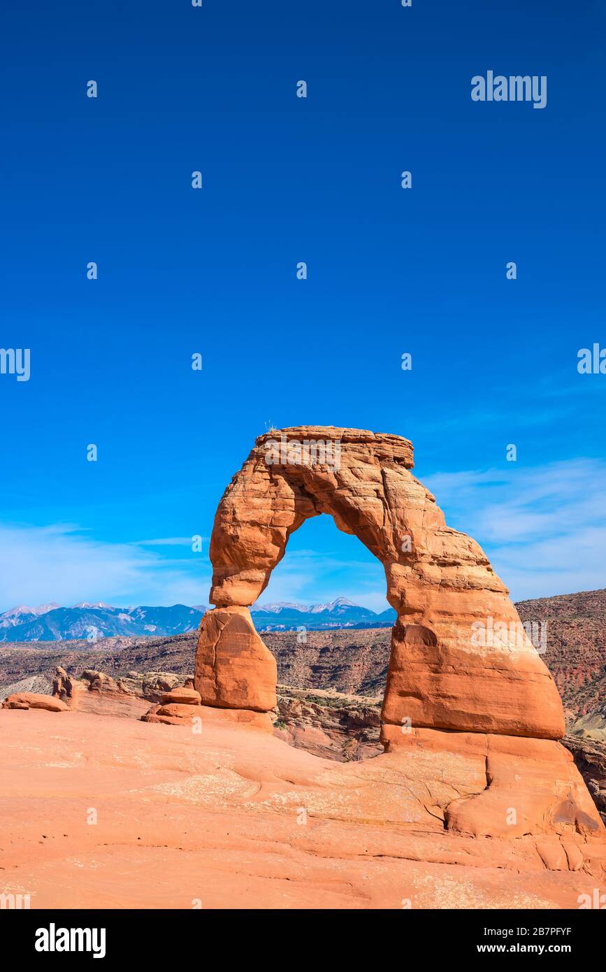 Delicate arch in arches national park with blue sky, vertical. Stock Photo