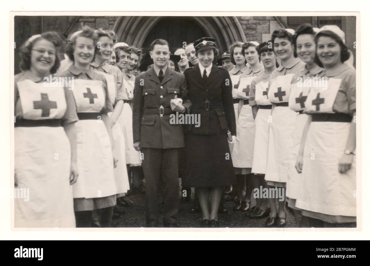WW2 era photo of happy attractive British Red Cross military nurse officer VAD in service uniform wearing a British Red Cross Society cap badge, on a cap -  marrying an RAF airman, Bristol, England, U.K. dated January 1944 Stock Photo