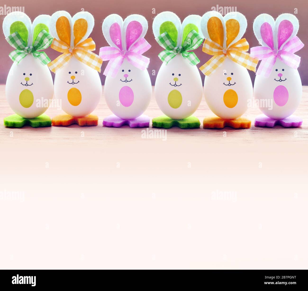 Group Easter eggs with the Bunny ears on pink background. Easter concept. Stock Photo