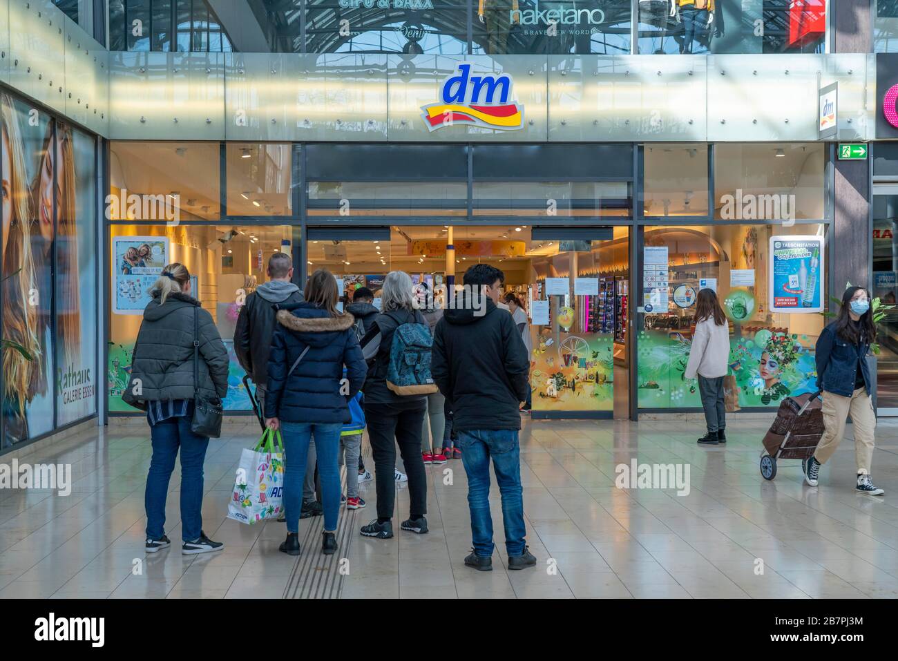 Effects of the coronavirus pandemic in Germany, Essen, shopping centre  Rathaus Galerie, drugstore DM, queue in front of the shop, as only a  maximum nu Stock Photo - Alamy