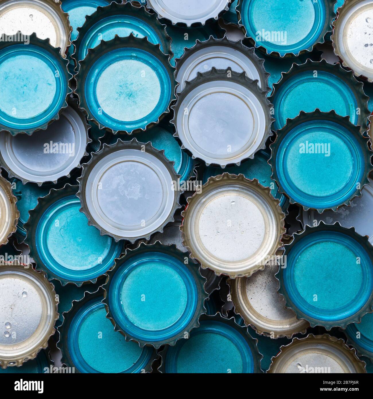 A pile of blue and white beer caps Stock Photo