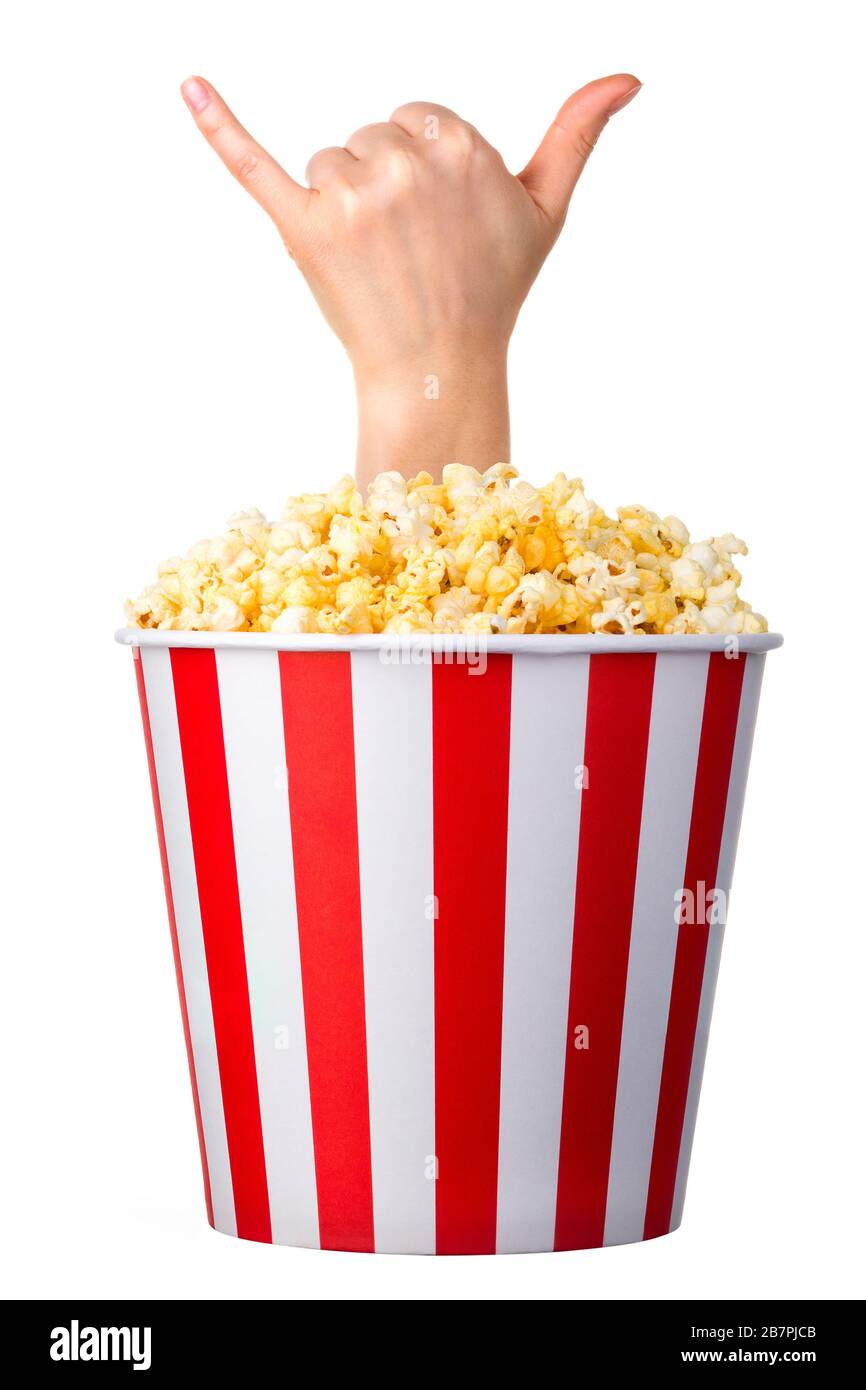 Female hand sticks out of a bucket with popcorn isolated on white background Stock Photo