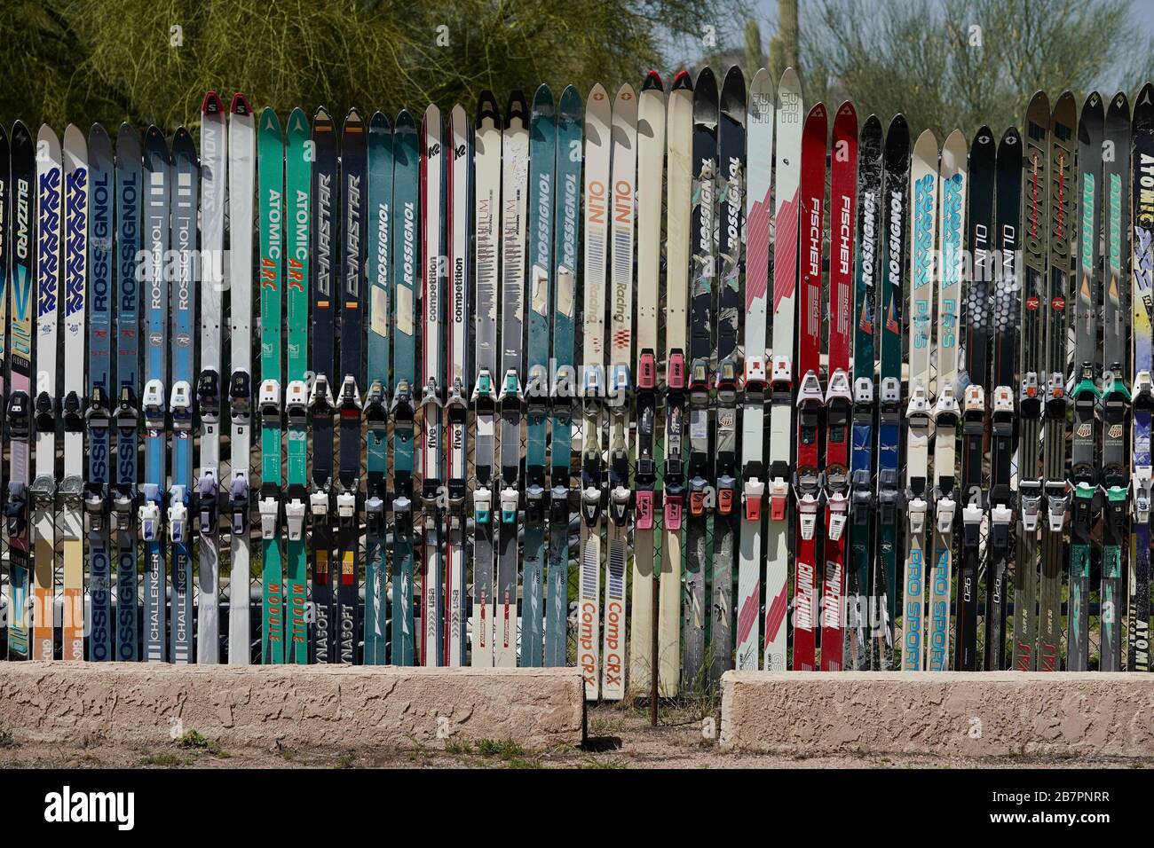 A fence made of repurposed old vintage skis. Stock Photo