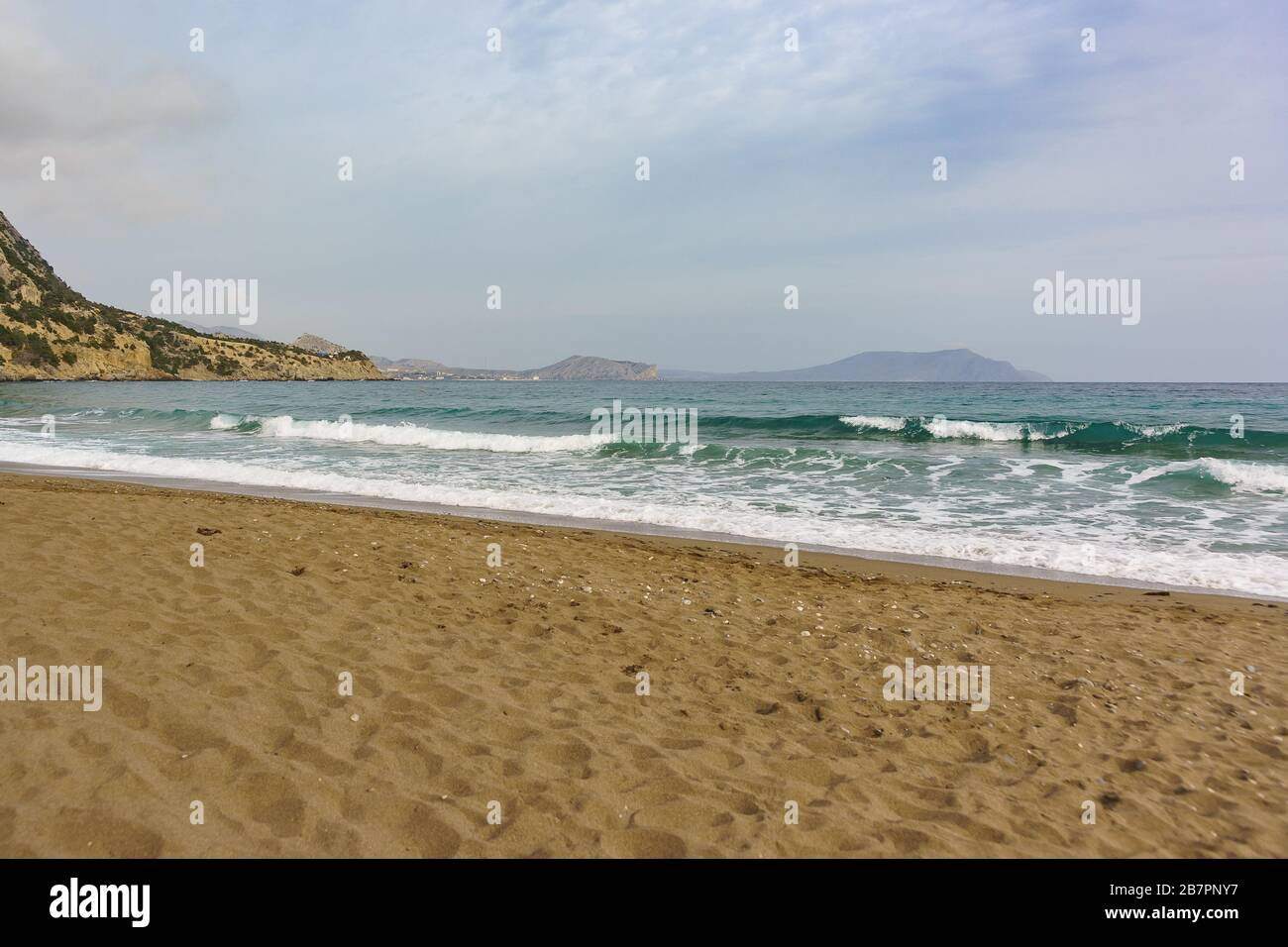 A calm sea is beautiful emerald color and the sandy beach. Crimea, Novy Svet village in the offseason Stock Photo