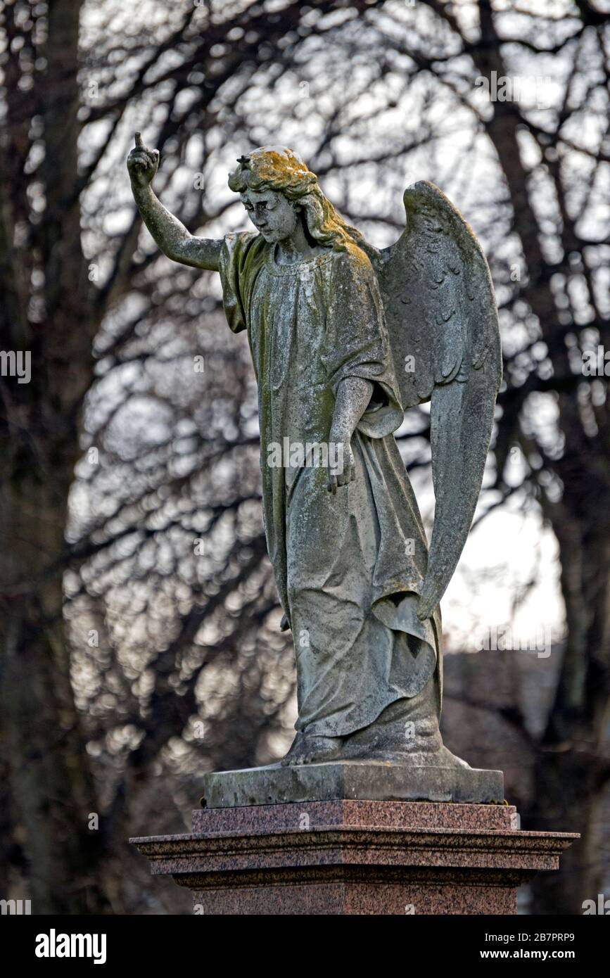 Statue of an angel pointing to the heavens in Morningside Cemetery Edinburgh, Scotland, UK. Stock Photo