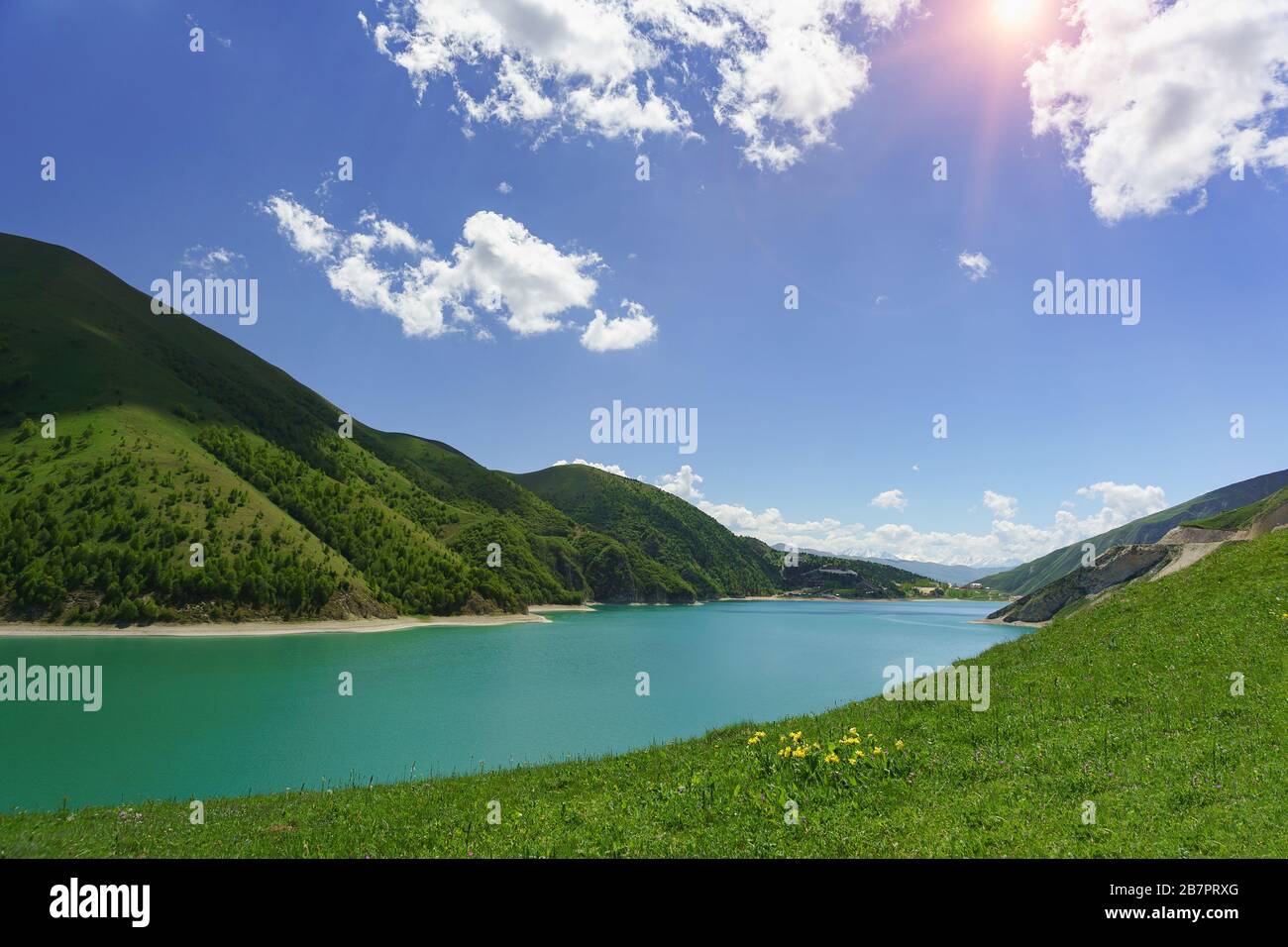 Bright Sunny day near the beautiful mountain lake Kezenoi am in Vedensky district, Chechen Republic. Juicy greens in early summer. Russia, North Cauca Stock Photo
