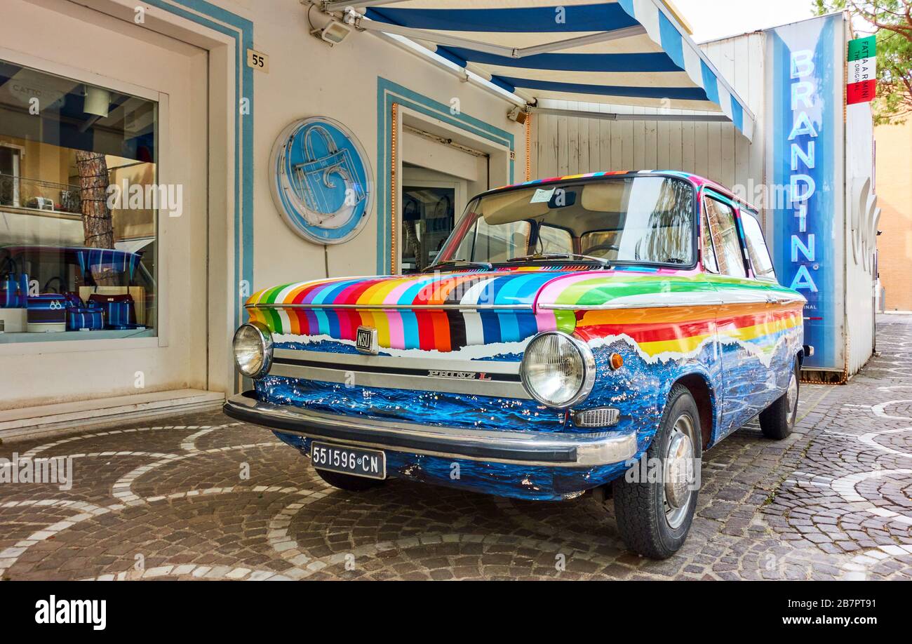 Cattollca, Rimini, Italy - February 29, 2020:  Colorful vintage car NSU Prinz L parked next to Brandina store in small italian town Stock Photo