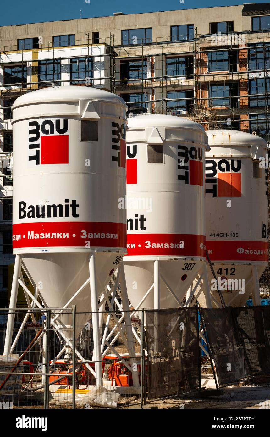 Three Baumit pump beton concrete movable silos for drymix mortars or Baumit Smarter Dry Mortar Silo at construction site as modern builder's solution Stock Photo