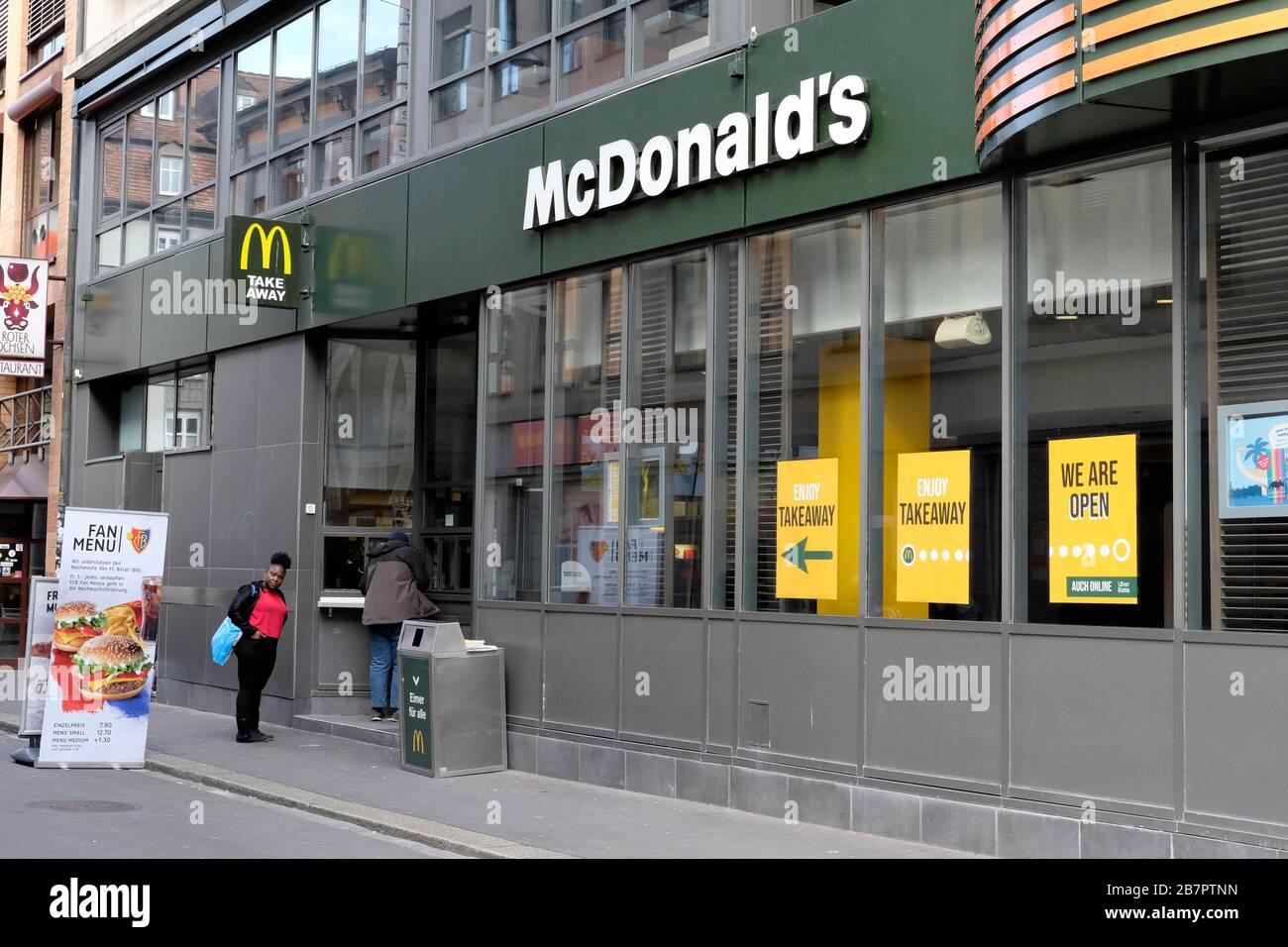All restaurants and non essentiall shops are closed because of coronavirus. McDonalds is open for take away only. Basel, Switzerland Stock Photo