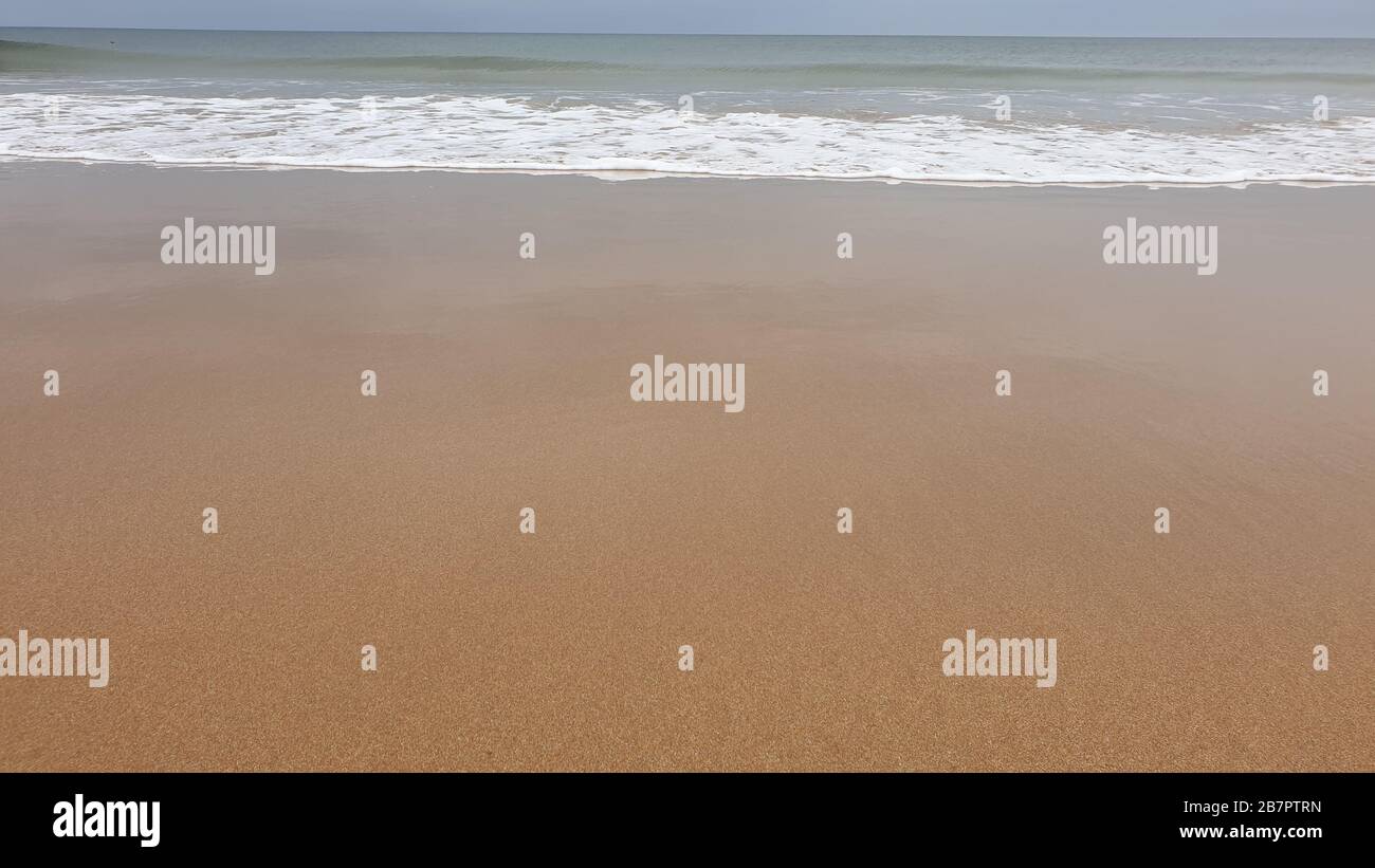 Waves breaking on beach Stock Photo - Alamy