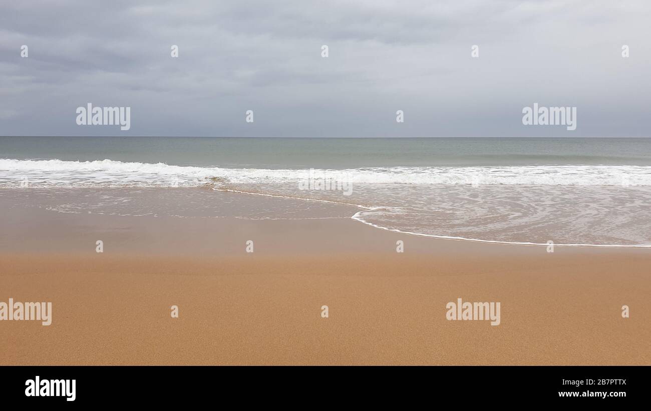 Waves breaking on beach Stock Photo - Alamy