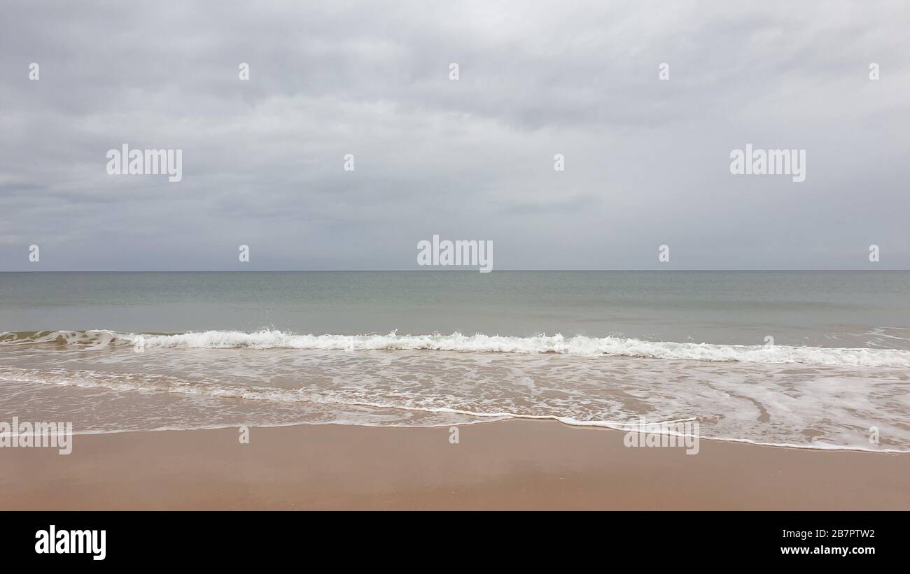 Waves breaking on beach Stock Photo - Alamy