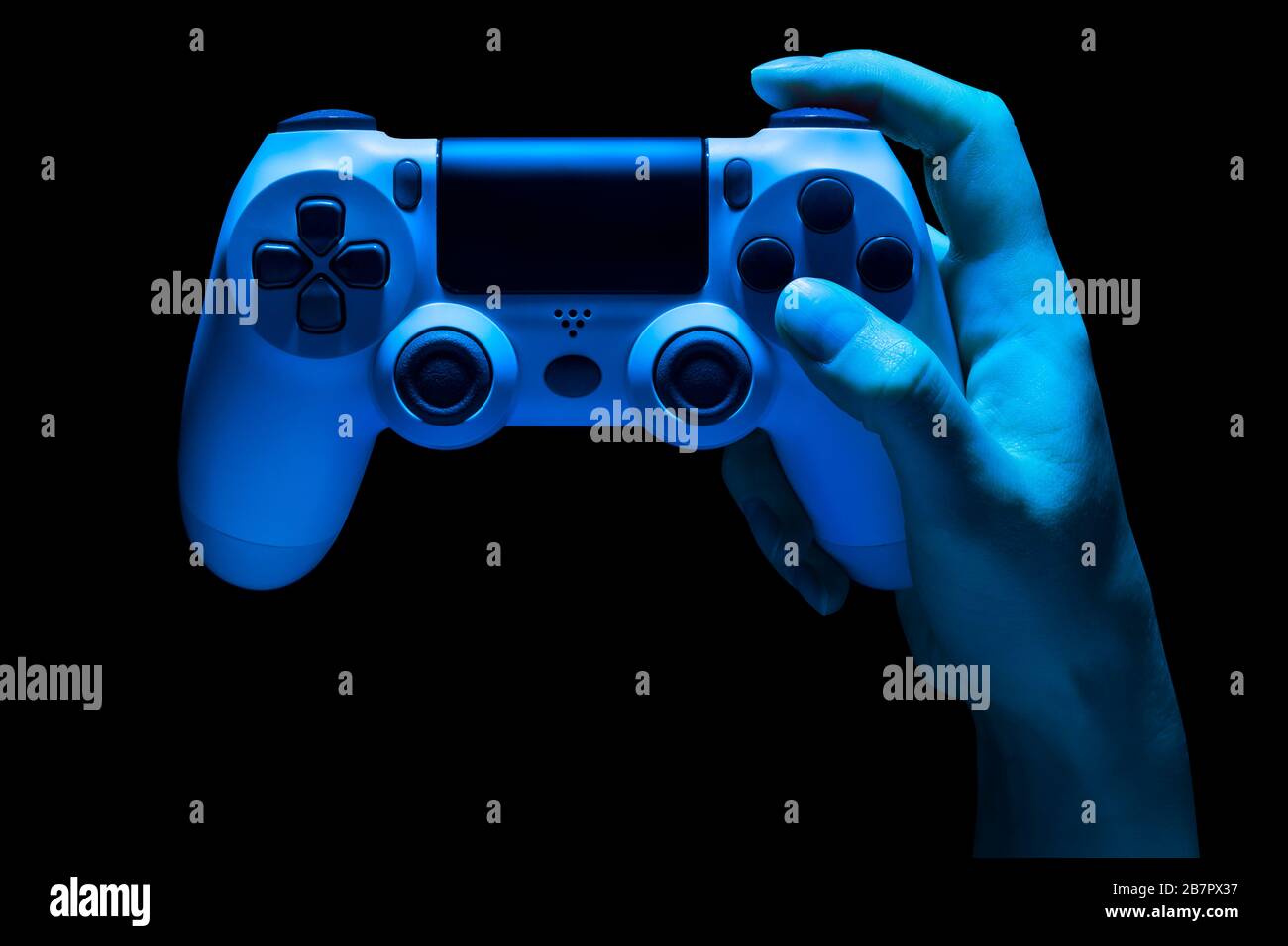 Hyman hand holding white video game gamepad in neon lights isolated on ...