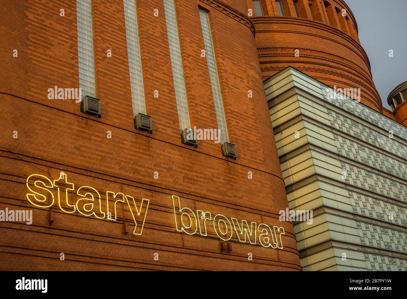 Neon lettering on the facade of shopping, art and trade center 'Stary Browar' in Poznan, Poland 2019. Stock Photo