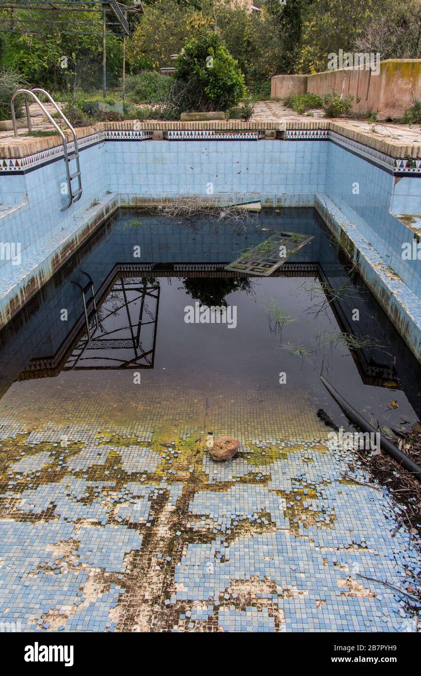 a dirty and abandoned pool with little water, abandoned pool, abandoned
