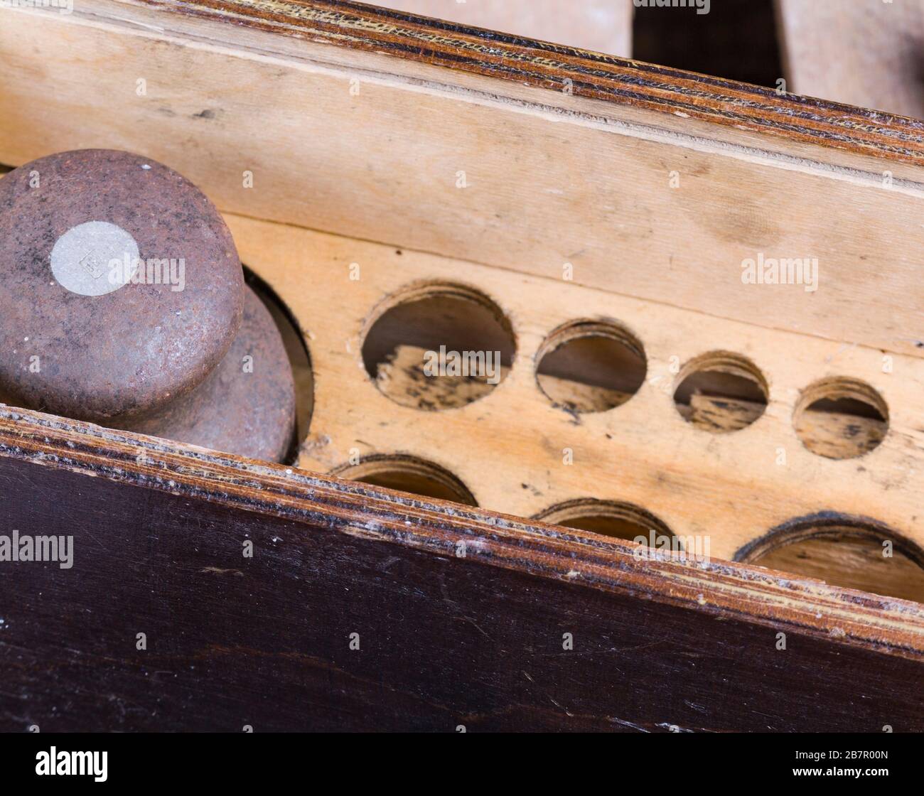 old vintage iron weights for weighing goods on a wooden background