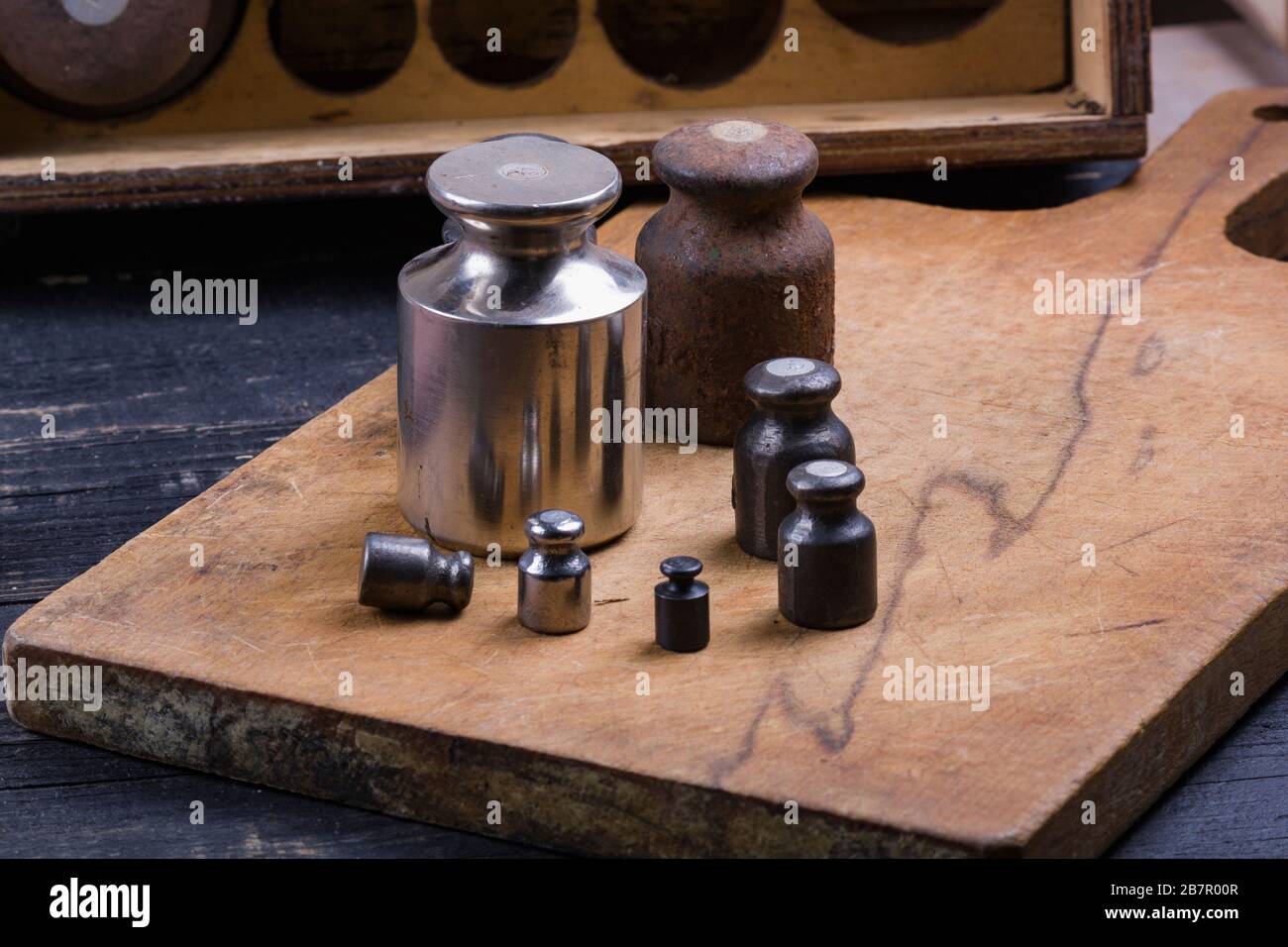 old vintage iron weights for weighing goods on a wooden background
