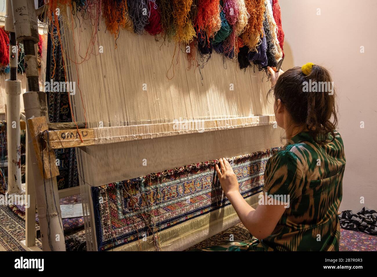 Woman Weaving a Carpet, Bukhara, Uzbekistan Stock Photo