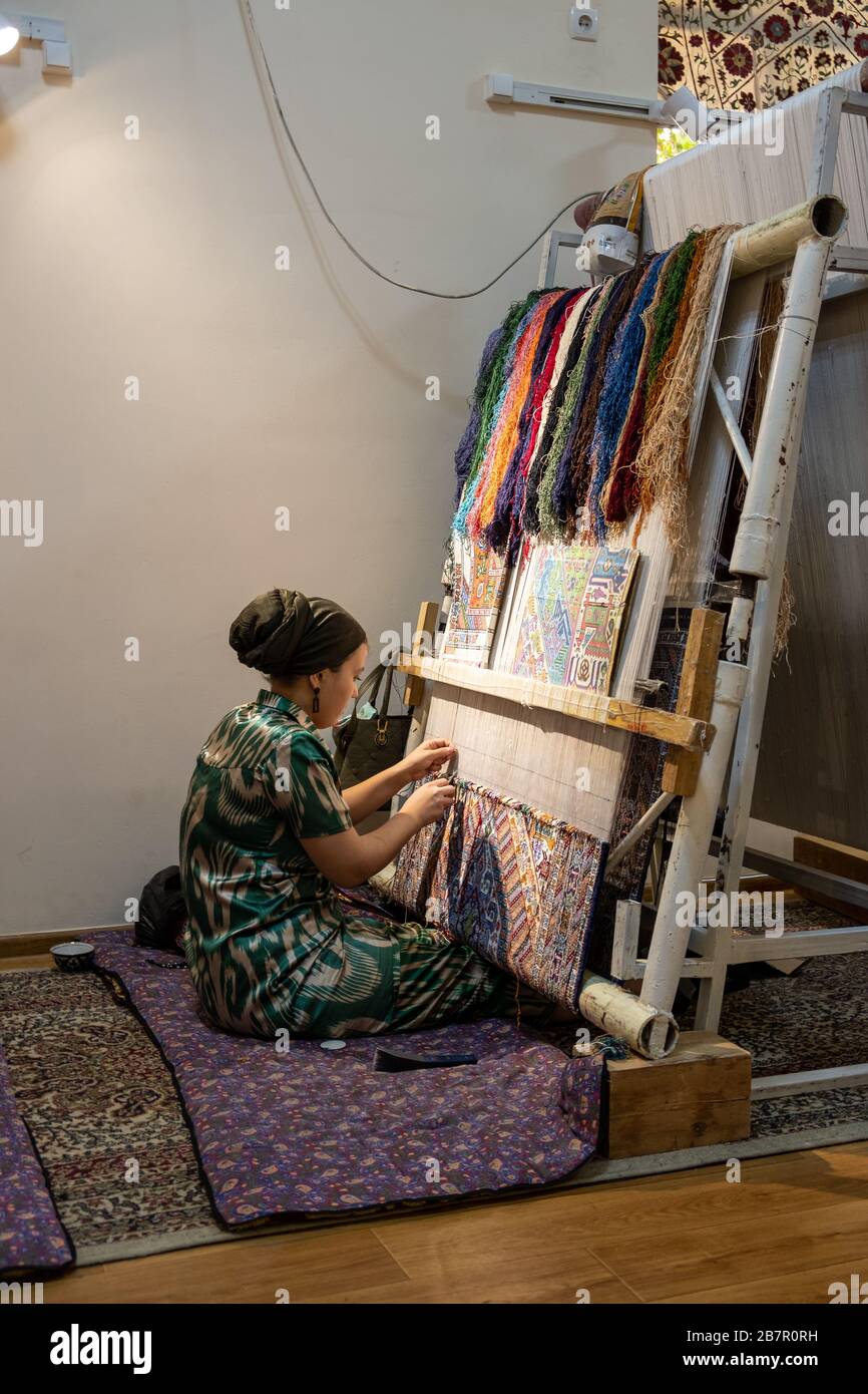 Woman Weaving a Carpet, Bukhara, Uzbekistan Stock Photo