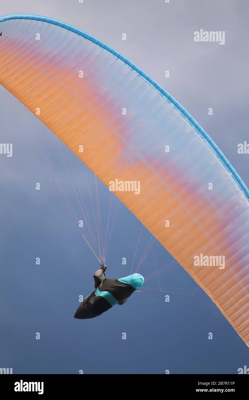 Paraglider in the air on a cloudy day Stock Photo