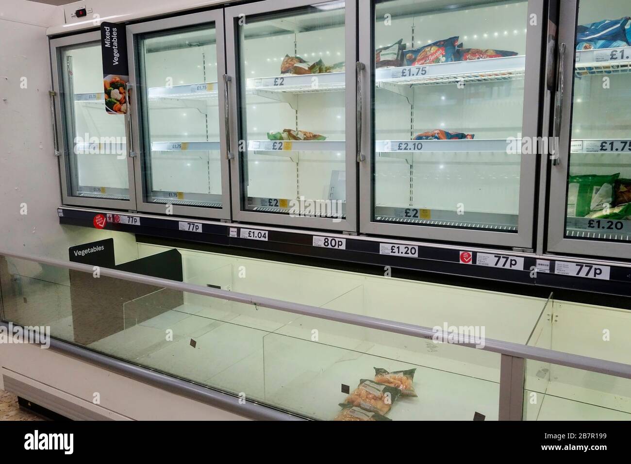 Empty freezer cabinets in a Tesco store in Surrey, UK due to panic buying because of coronavirus. March 17th 2020 Stock Photo
