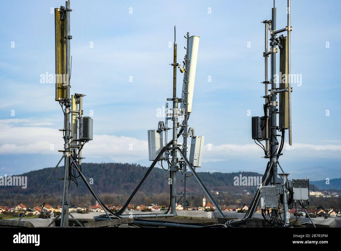 Cellular radio telecommunication network antenna mounted on a metal pole  providing strong signal waves from the top of the roof across big city  Stock Photo - Alamy