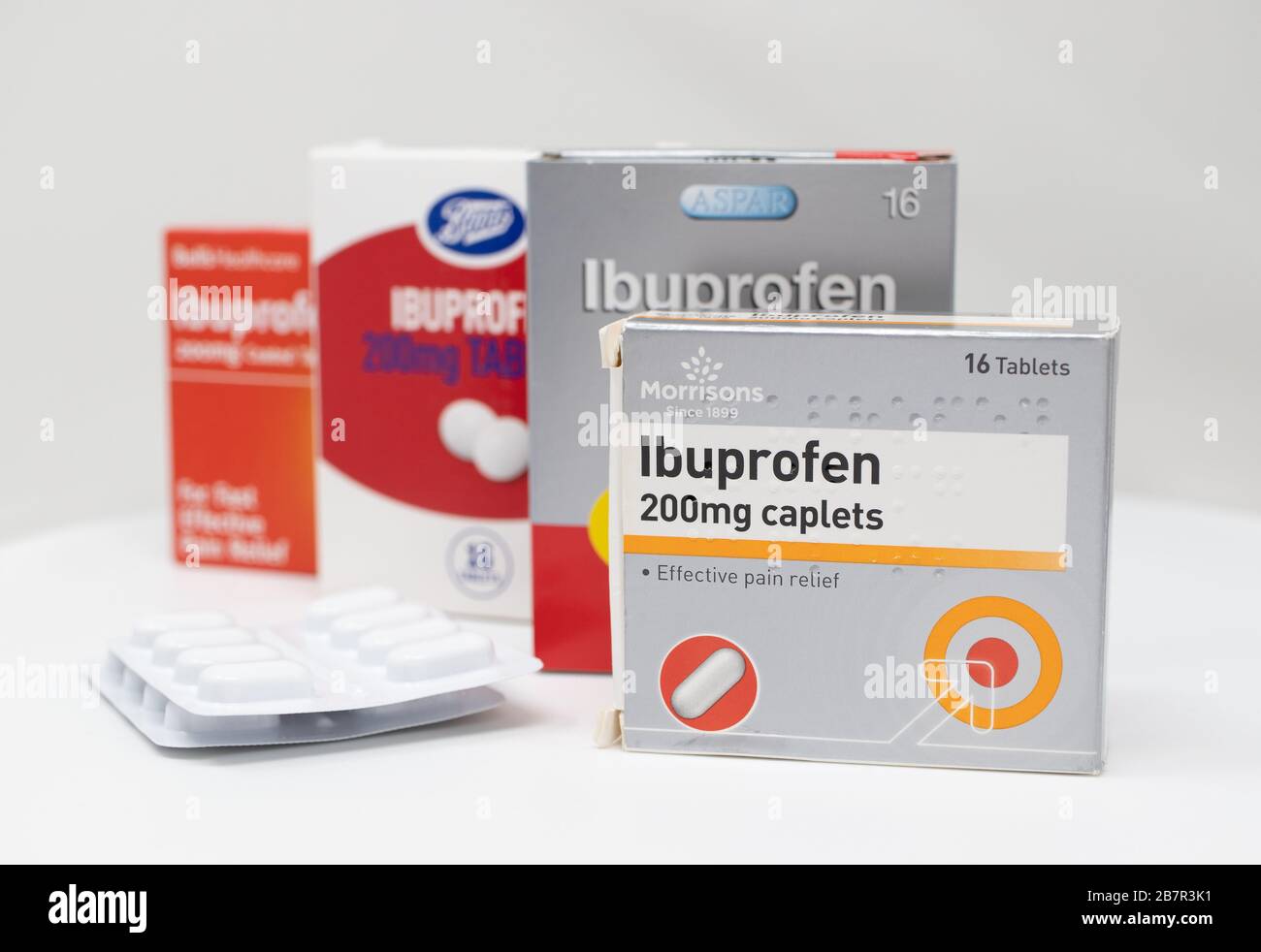 London / UK - March 17th 2020 - Supermarket brands of Ibuprofen anti-inflammatory medication boxes and packs of tablets on a white background. Stock Photo